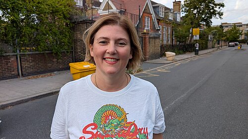 Photo of a woman in front of a school